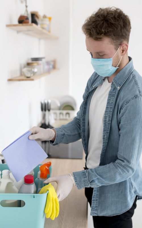 high-angle-man-with-mask-cleaning
